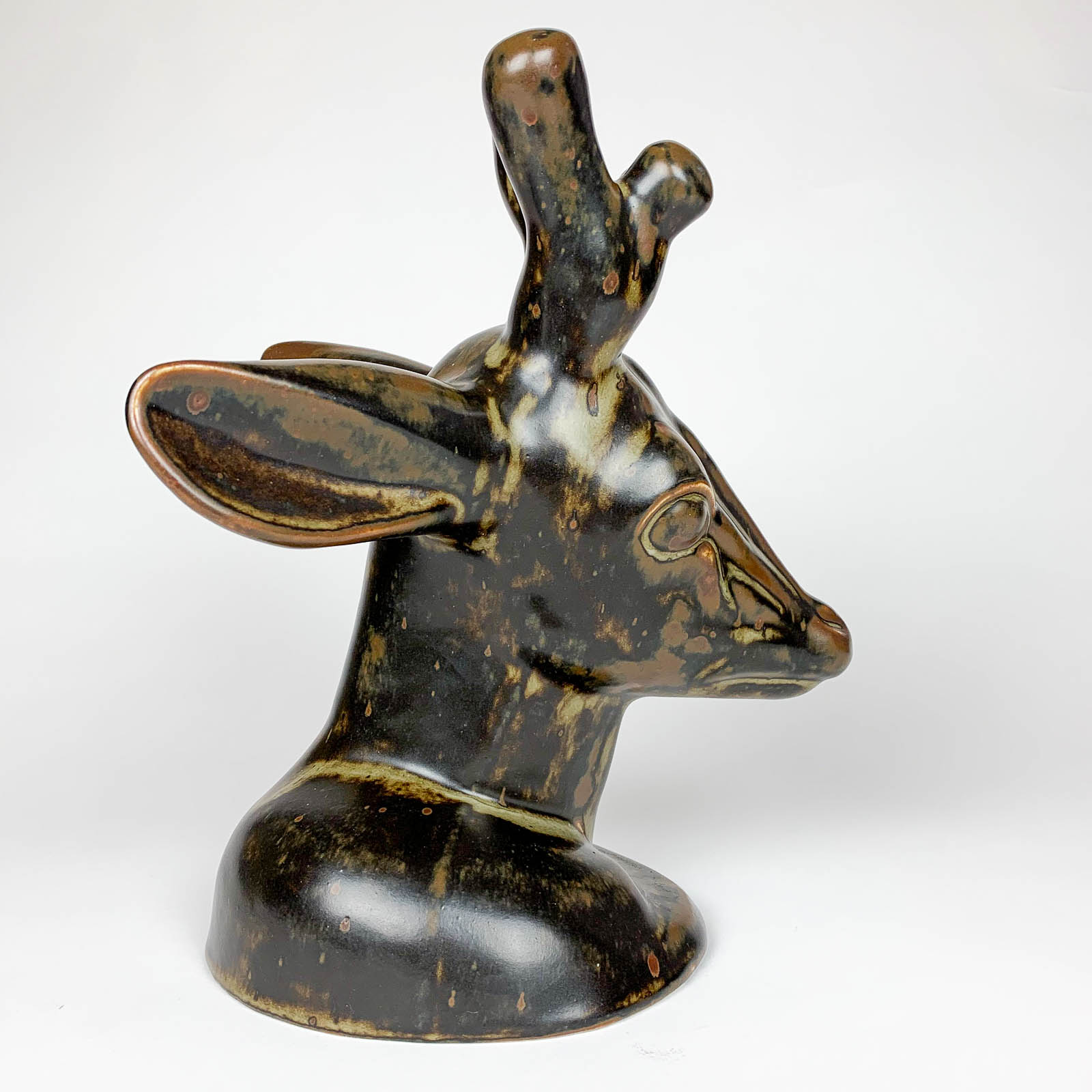 A stoneware Deerhead sculpture, model no: 20.803, sculpted by Axel Salto in 1946 and executed by Royal Copenhagen in 1950.