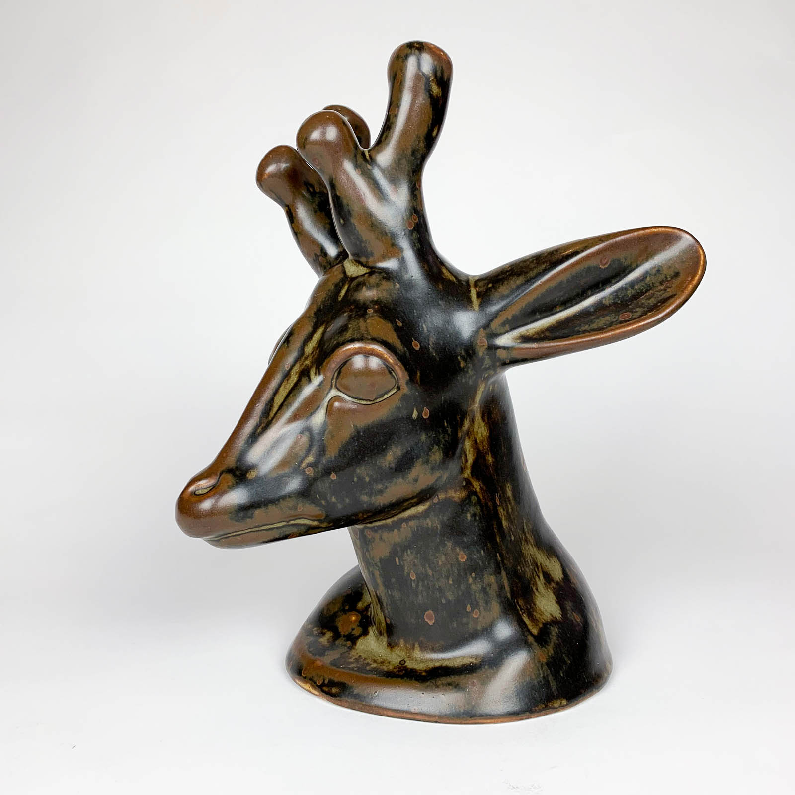 A stoneware Deerhead sculpture, model no: 20.803, sculpted by Axel Salto in 1946 and executed by Royal Copenhagen in 1950.